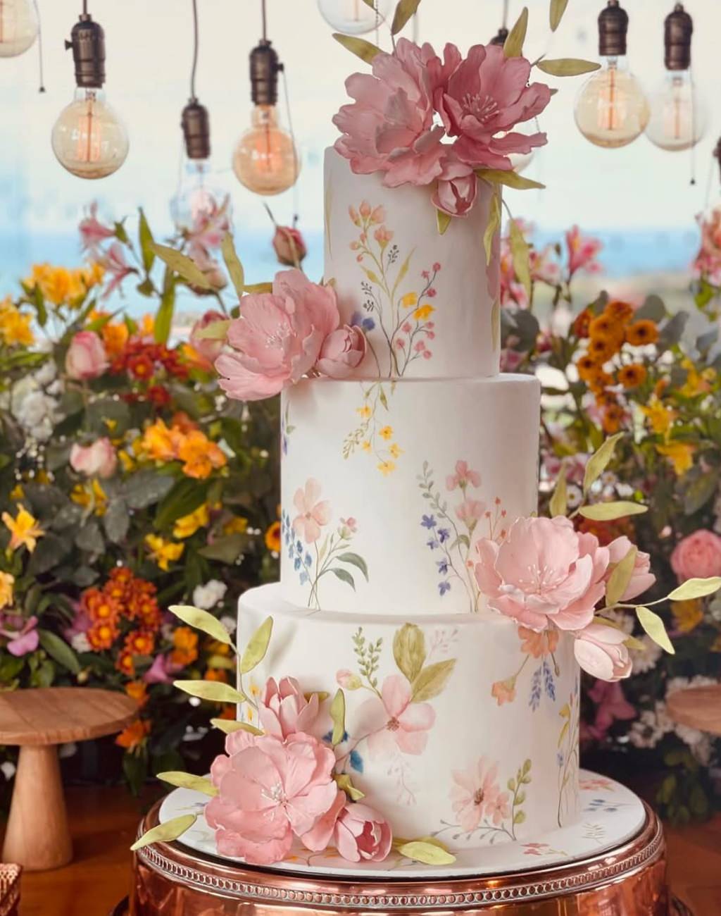 A beautiful 3-tier wedding cake with pink flowers