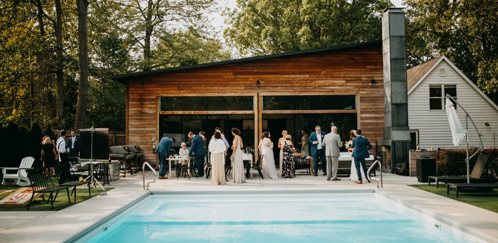 A wedding taking place at an airbnb with a pool