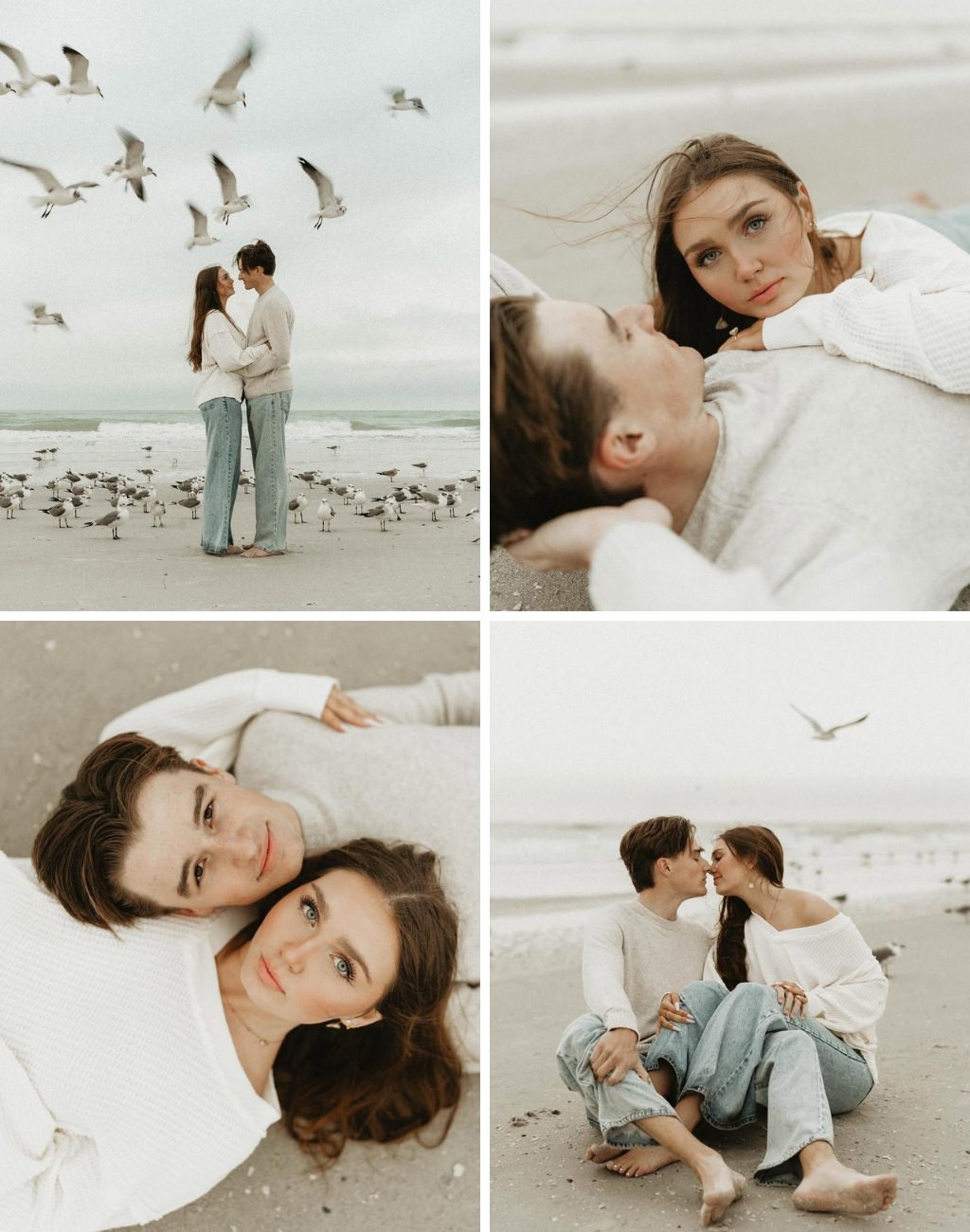 A couple taking engagement photos at the beach in jeans with birds flying around them