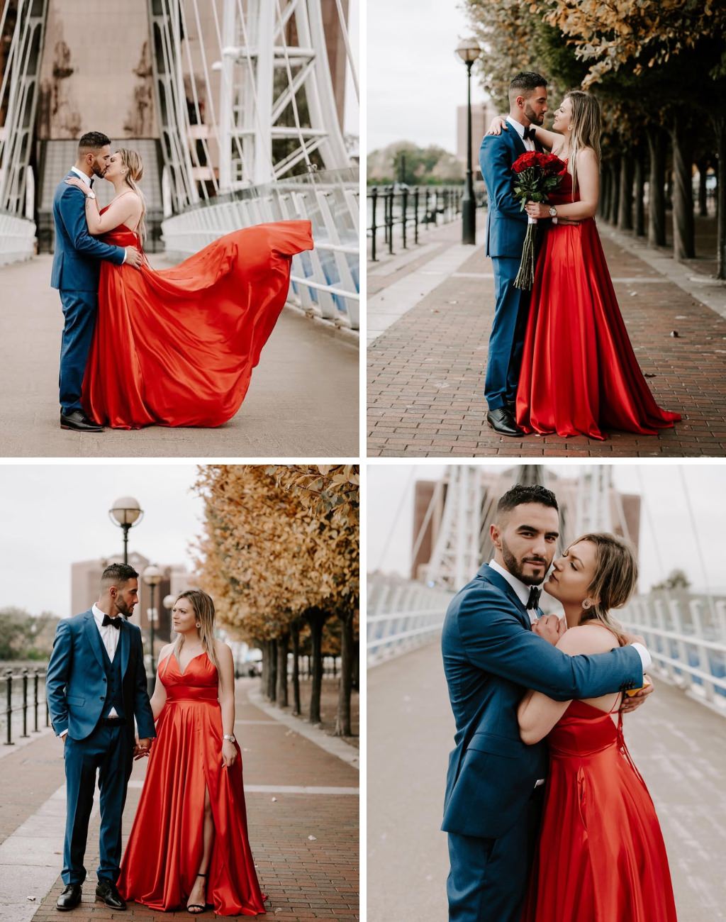 A couple posing outside for engagement photos. The girl is wearing a bright red dress and the guy is wearing a stylish dark blue suit.