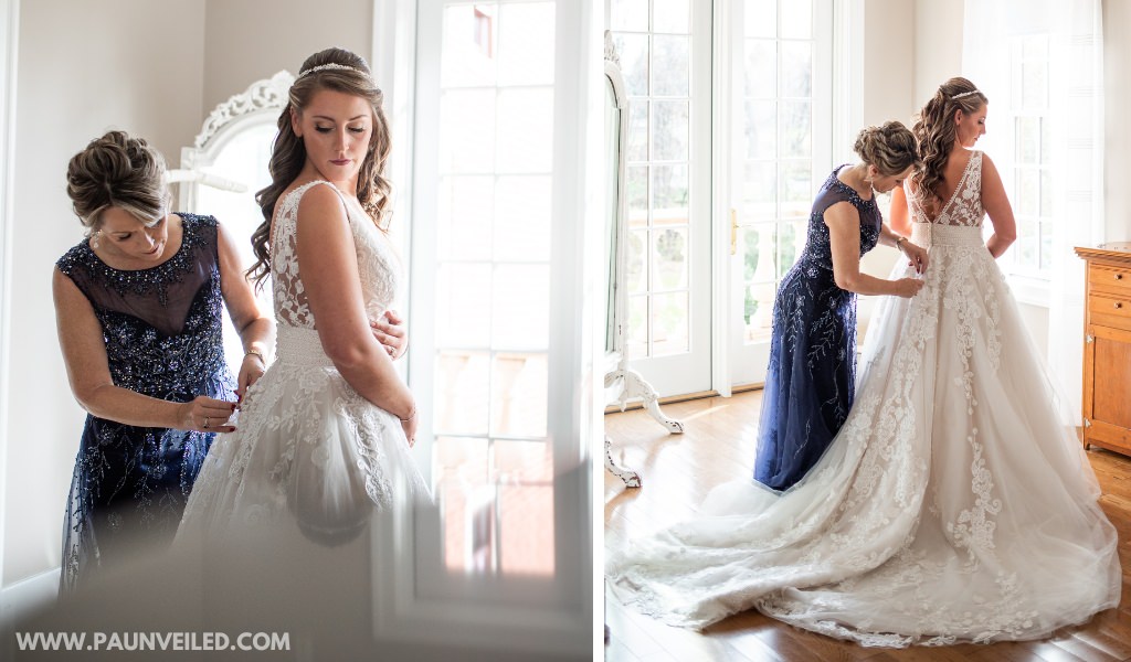 A mother of the bride helping the bride get dressed on the wedding day. This shows the mom buttoning the wedding dress.