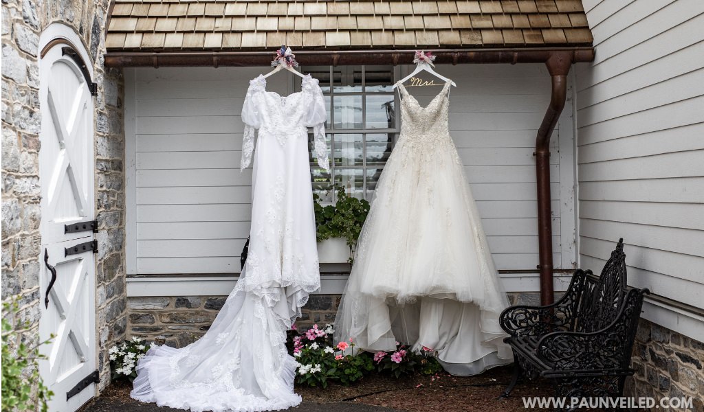 The bride's dress and the mother of the bride's old dress hanging up together