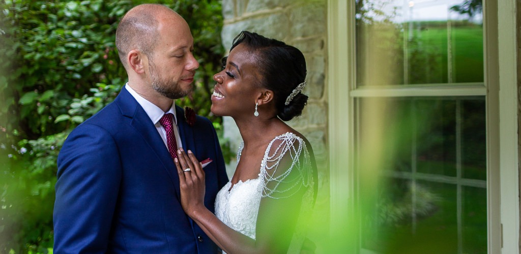 A bride and groom smiling at each each other