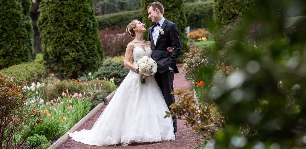 A bride and groom smiling at each other. This is for the blog post called how to plan a wedding in 8 months