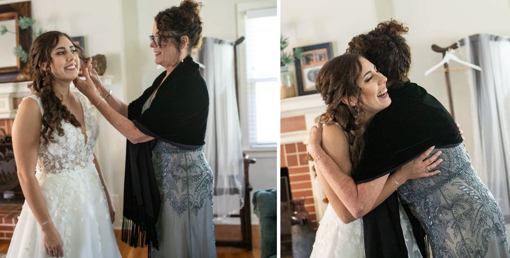 A bride's mom helping the bride with her earrings and then hugging