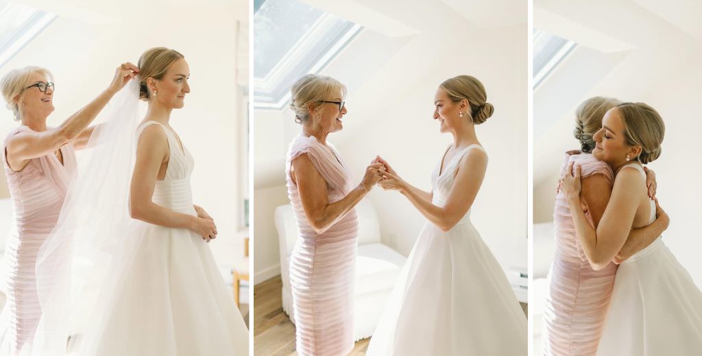 A bride's mom helping her daughter get ready for the wedding by helping her with her dress and veil.