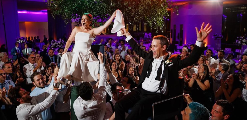 A couple taking part in a wedding Hora dance
