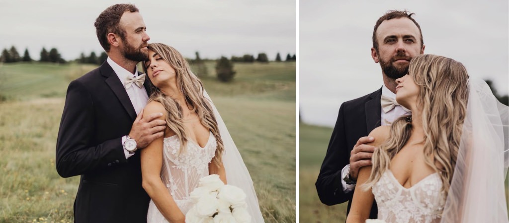 A bride and groom posing in a field