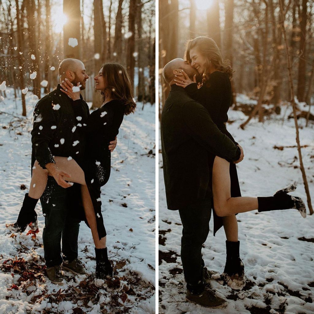 A couple in all black posing for photos in the snow
