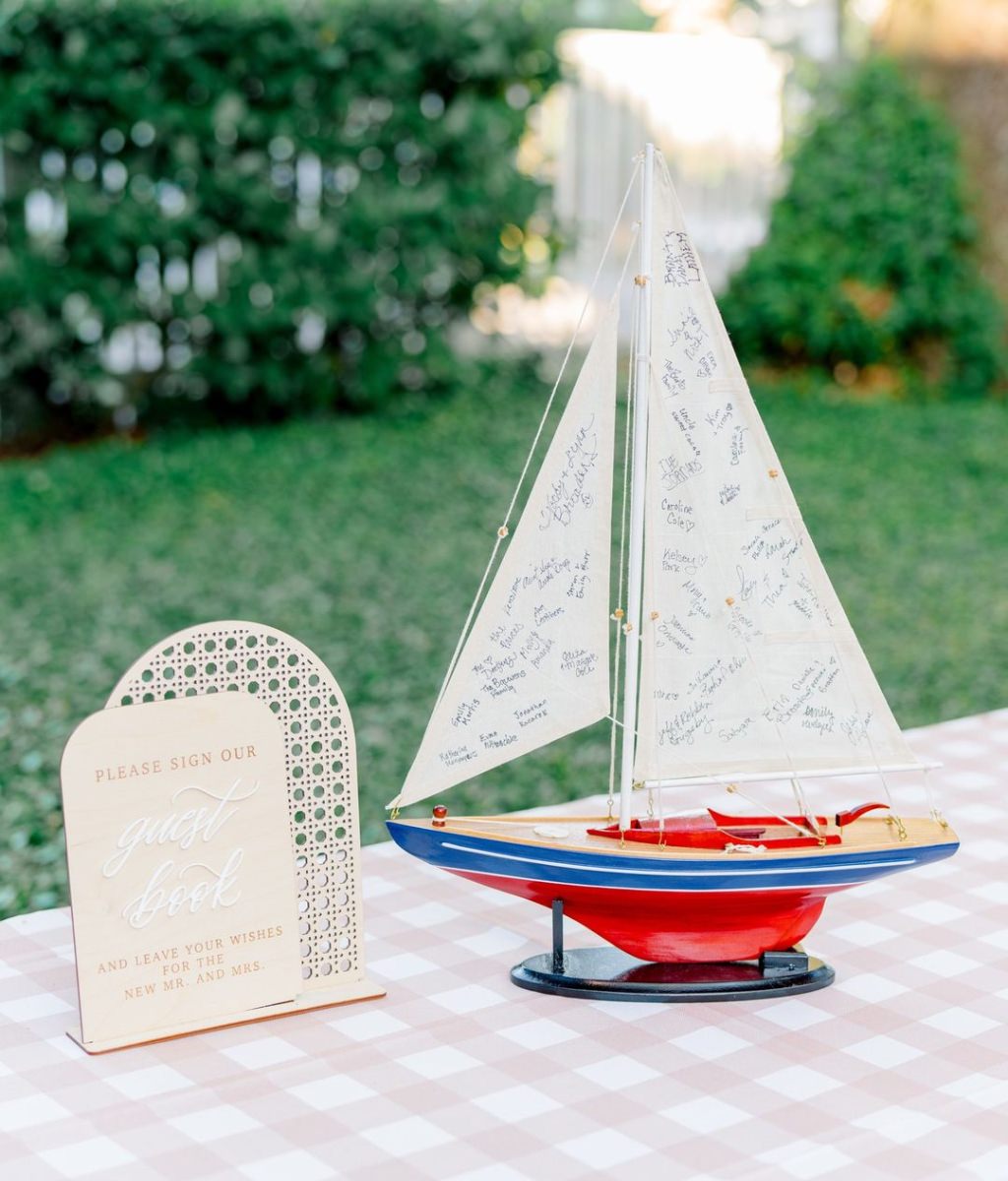 This couple has a love for boating and sailing so they used a miniature sailboat as their wedding guest book alternative