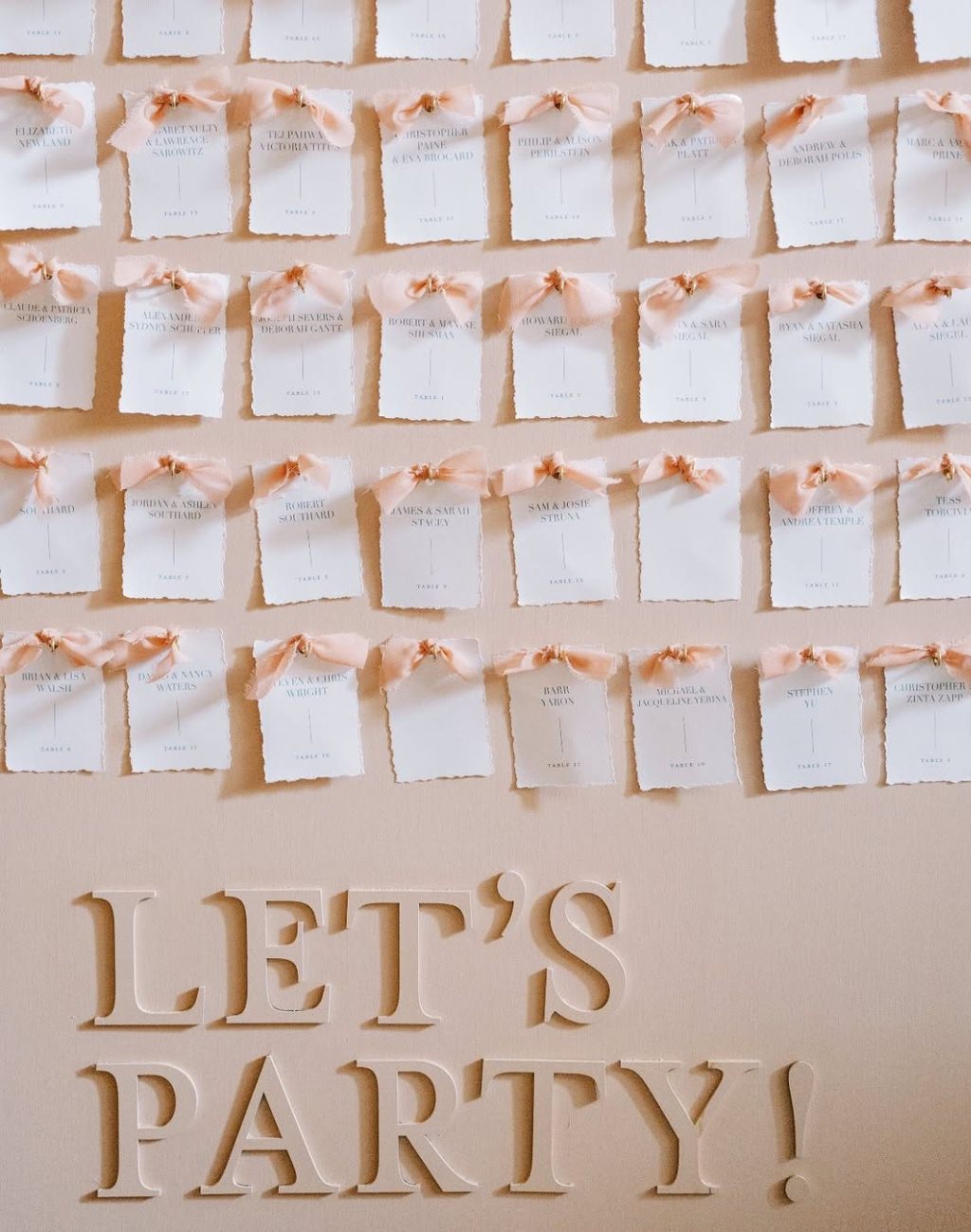 Cute pink bows for this coquette wedding seating chart