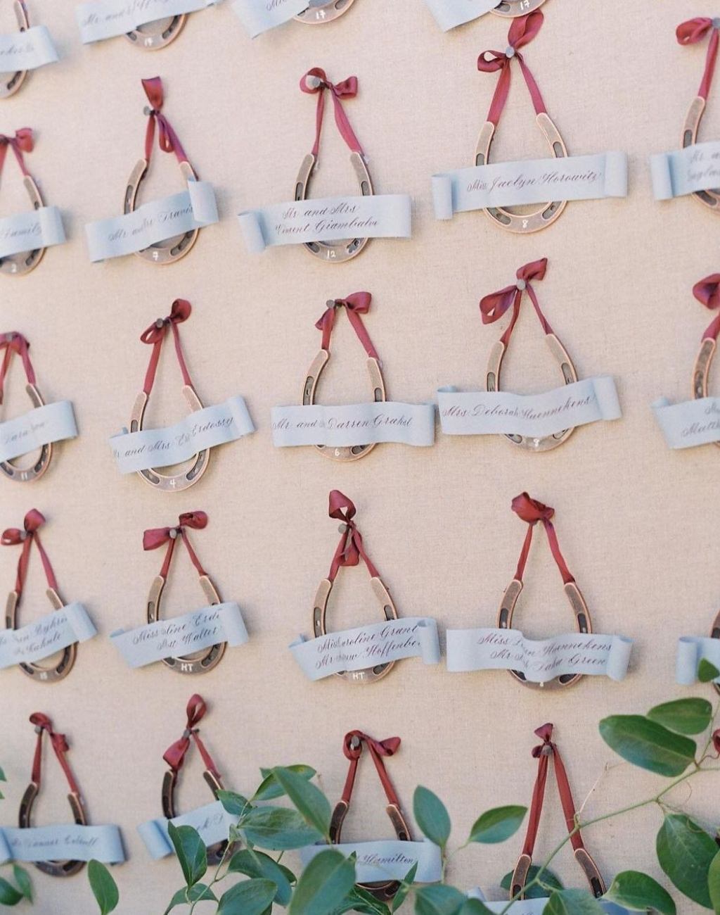 A lucky horseshoe wedding seating chart idea where each guest gets their own horseshoe ornament