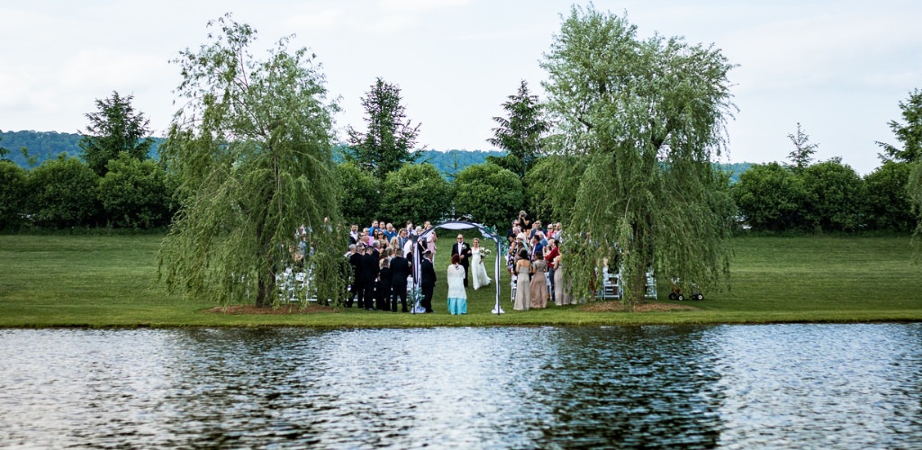 A wedding ceremony taking place at an outdoor wedding venue