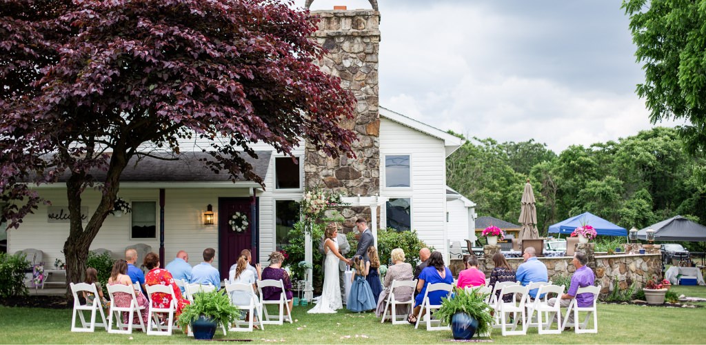A wedding ceremony taking place at the home of the bride's parents