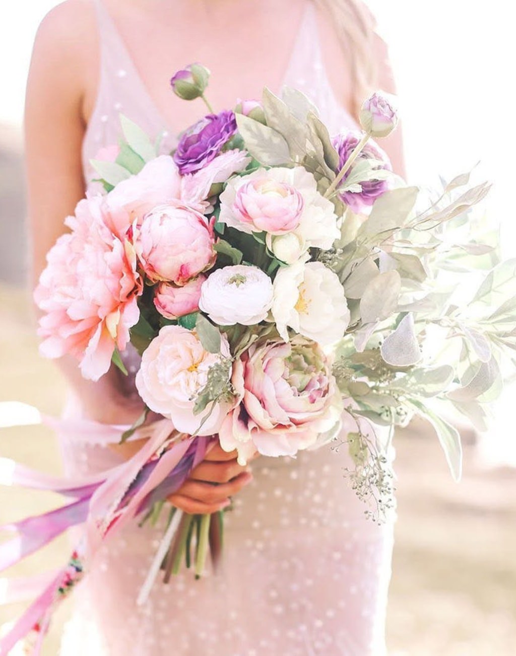A pink and purple spring wedding bouquet