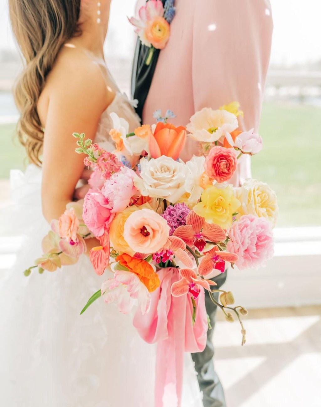 A beautiful spring wedding bouquet with pink and yellow flowers