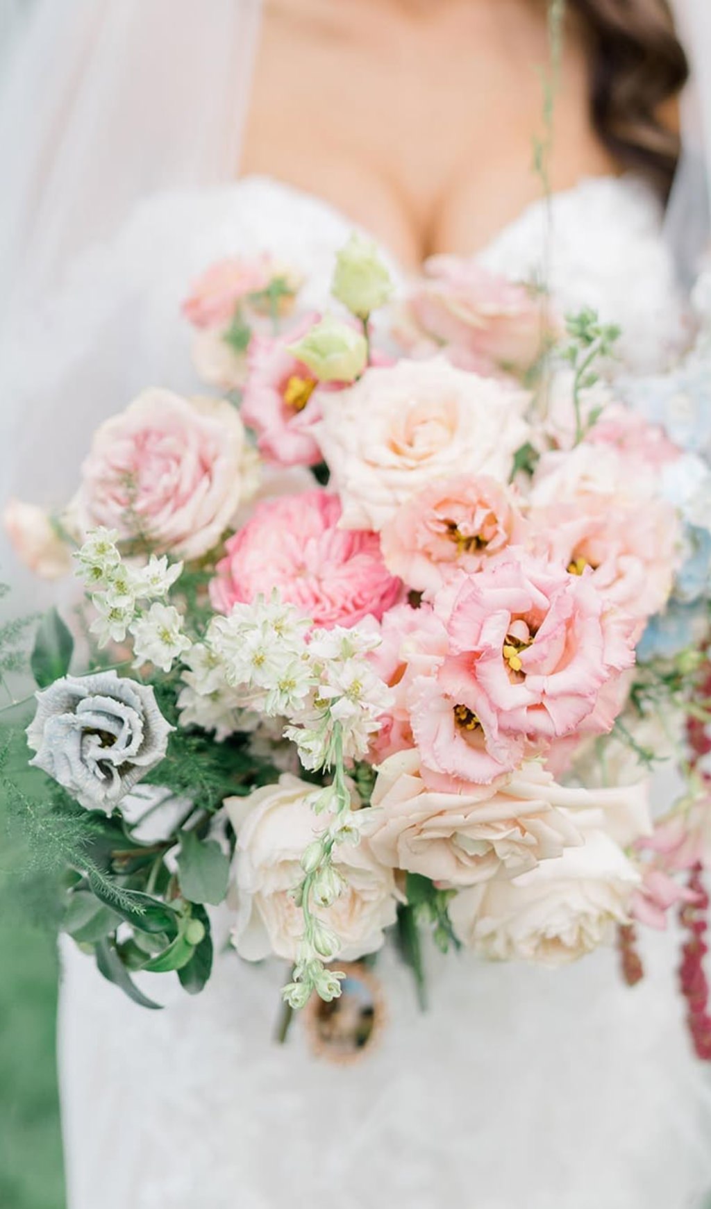 A pretty pastel summer wedding bouquet with lots of pink flowers
