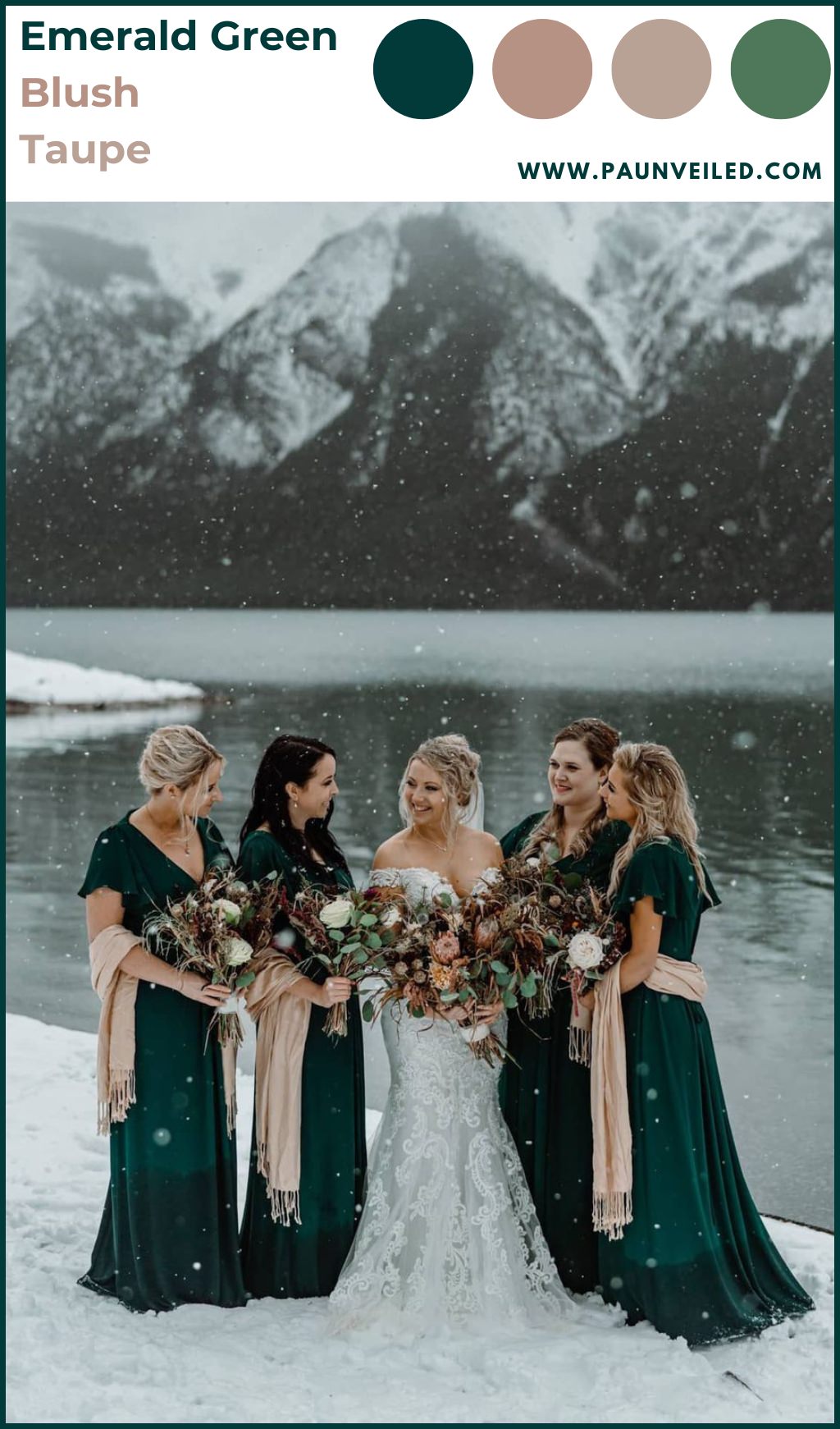 A bride posing with bridesmaids in emerald green dresses in winter as the snow is falling all around them.