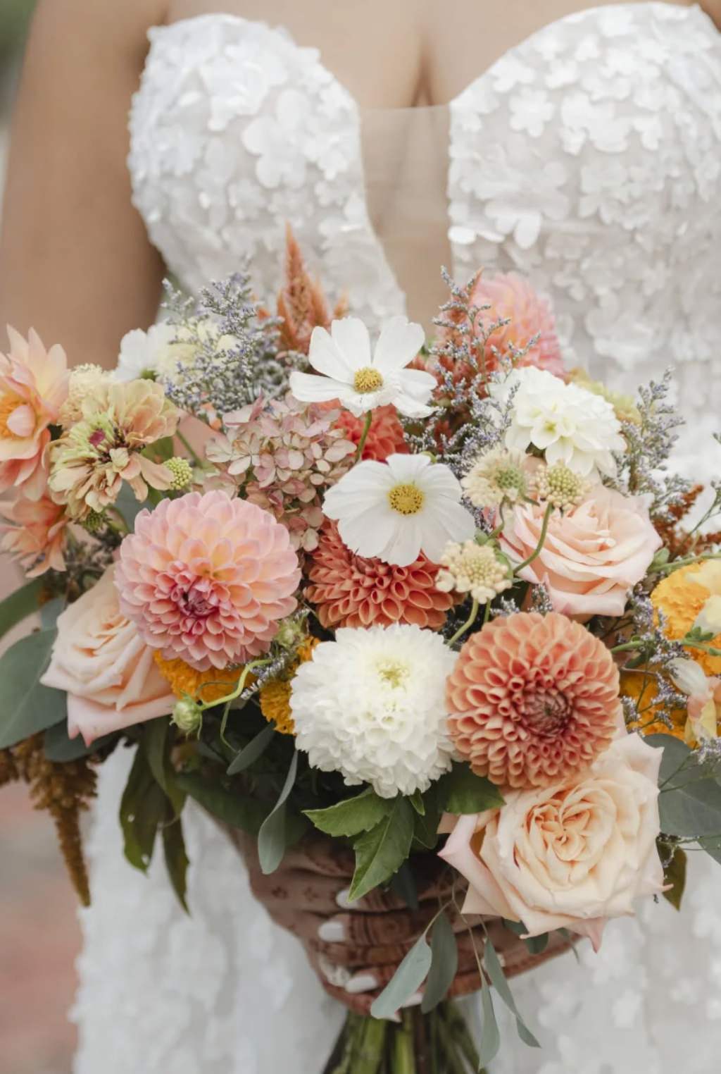 A gorgeous fall wedding bouquet with peach, brown, and white flowers