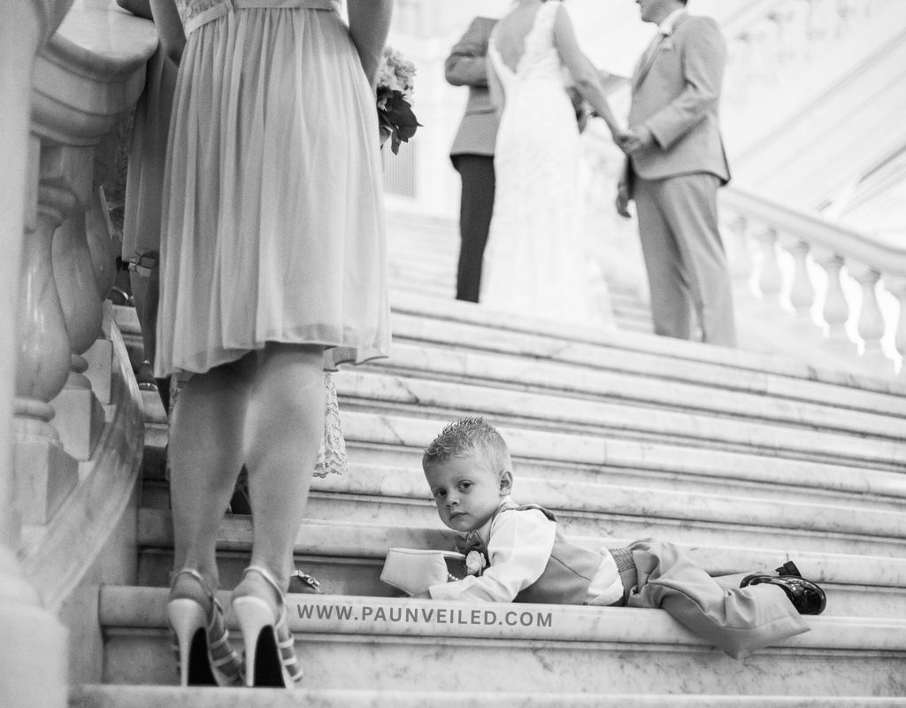 A bored ring bearer during the wedding ceremony