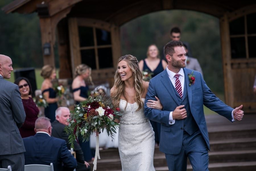 A bride and groom walking down the aisle